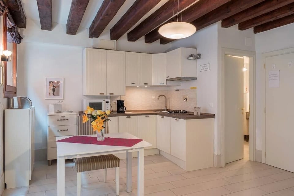 Deluxe Triple Room, Canal View | Private kitchen | Full-size fridge, microwave, stovetop, dishwasher