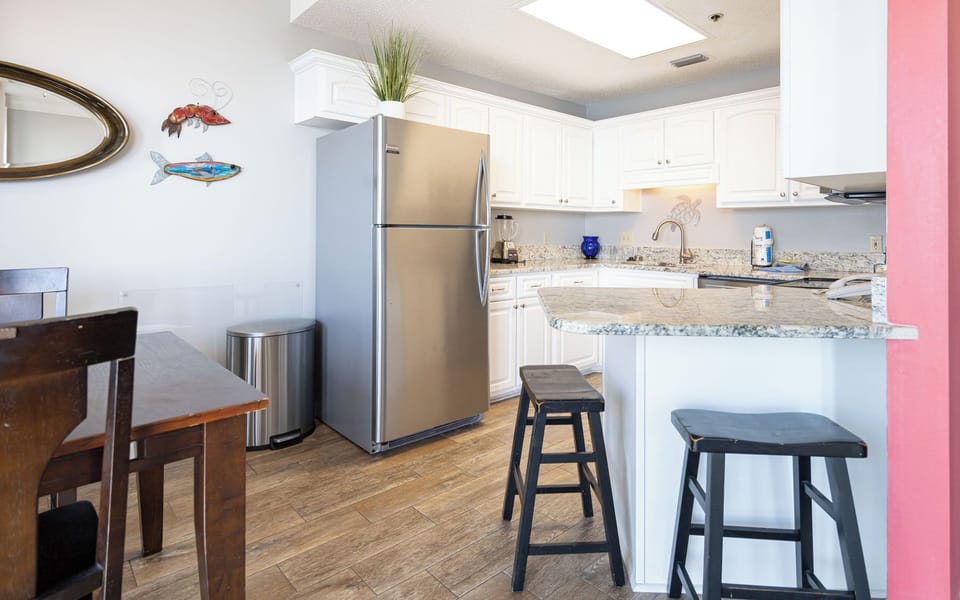 Experience family bonding as you share laughter at the dining table, with a vibrant kitchen just steps away