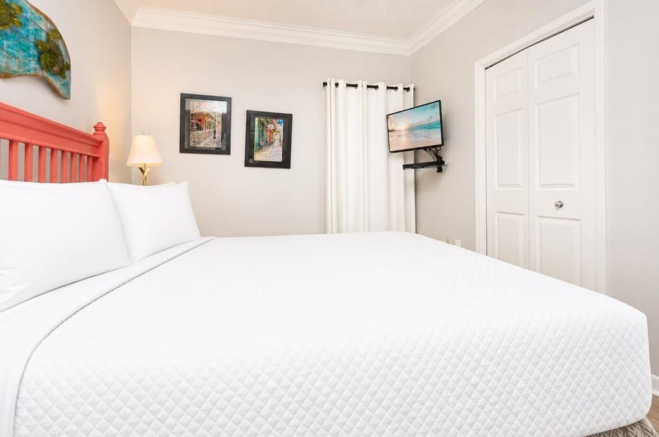 Relax in the master bedroom, where soft bedding and charming decor create the perfect retreat