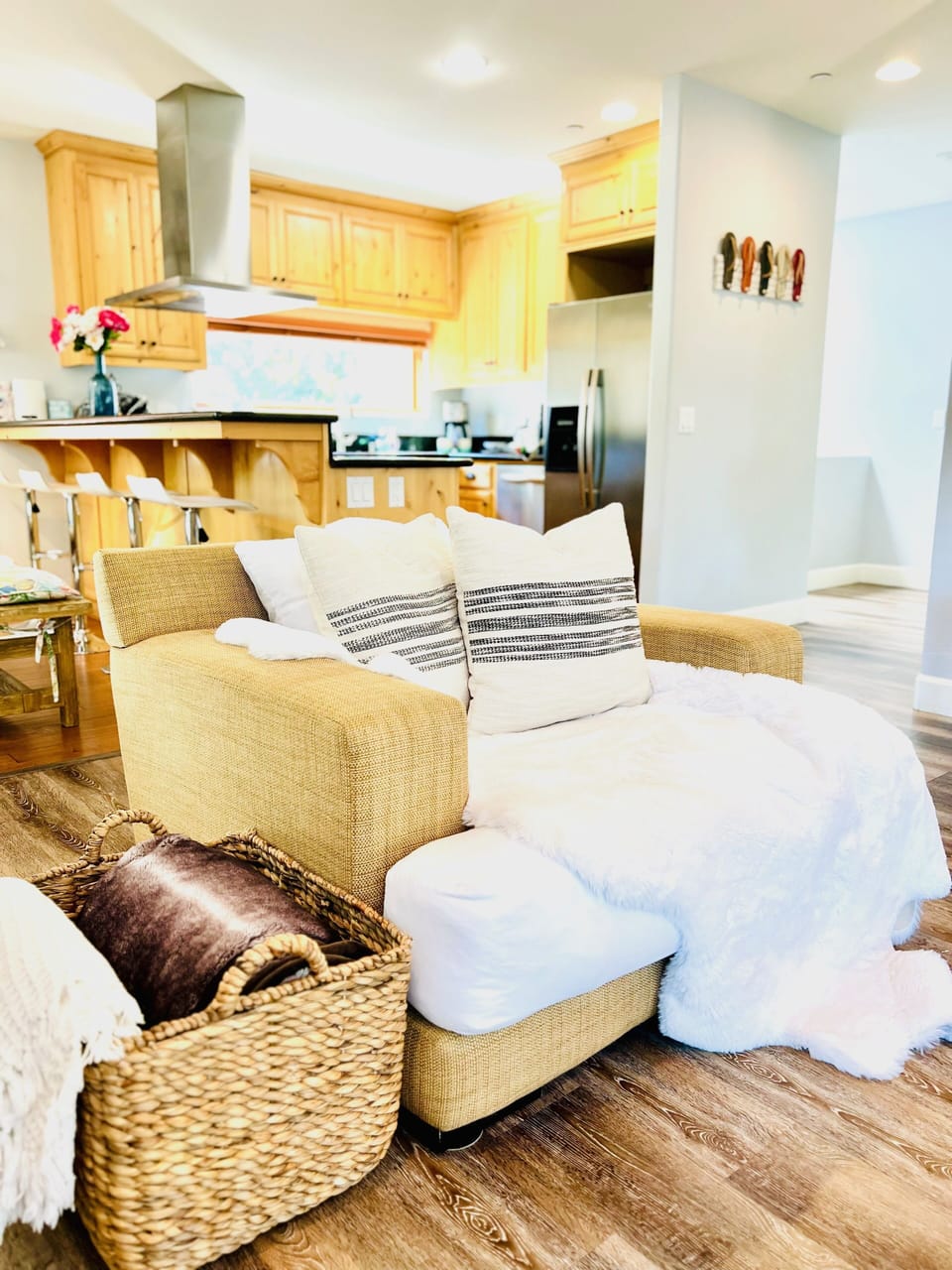 Spacious living room area with a large couch and two other soft comfortable seating chairs!