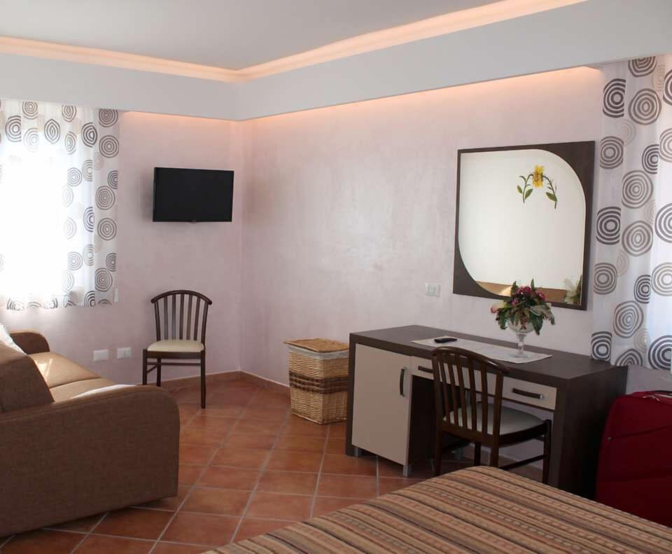 Family Quadruple Room | Living area | 32-inch flat-screen TV with satellite channels, TV