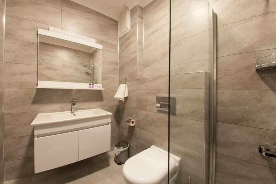Shower, hair dryer, slippers, towels