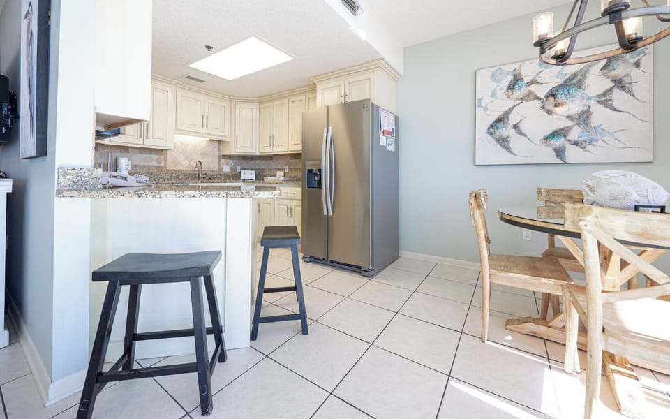 Enjoy a delightful meal at the table while taking in the beachfront view from this inviting and modern kitchen area
