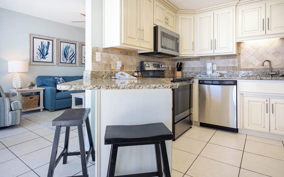 Enjoy a welcoming kitchen with modern appliances, perfect for preparing meals while relaxing in a beachside retreat