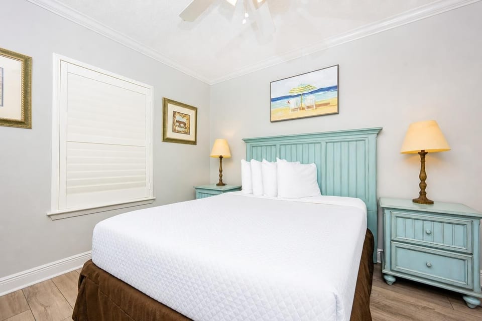 Rest in this tranquil guest bedroom featuring a comfortable queen bed, soft linens, and charming decor for a peaceful sleep