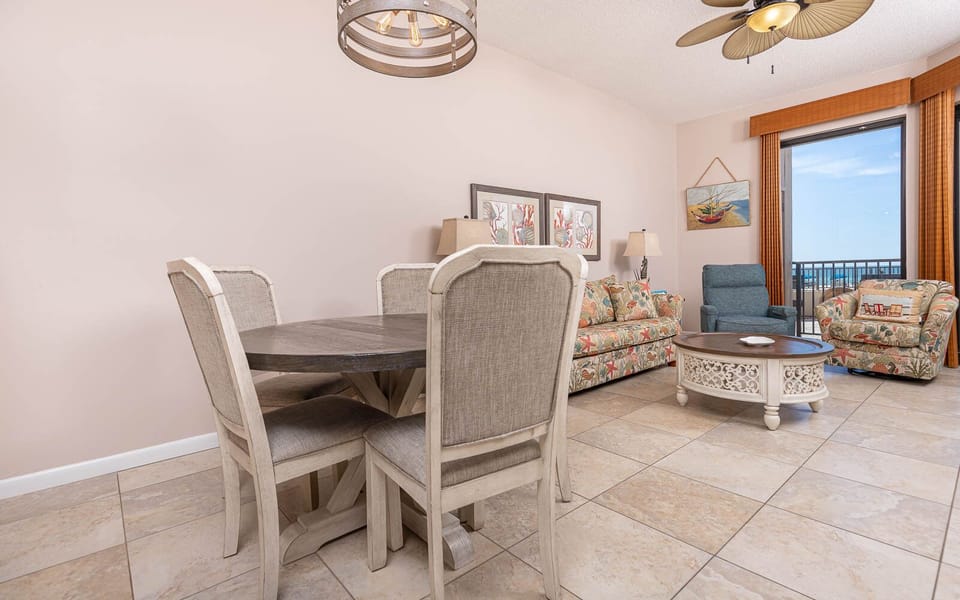 Gather around the round dining table while enjoying the colorful decor and comfortable seating in the inviting living area