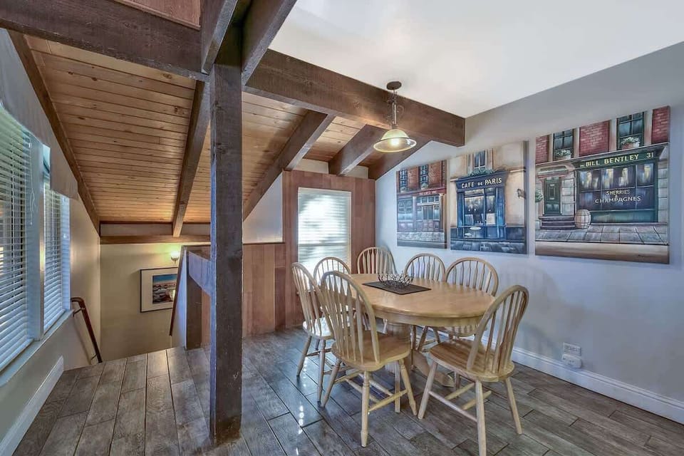 Cozy dining nook with rustic beams and warm light—perfect for shared meals, conversation, and relaxing after a day by the lake.
