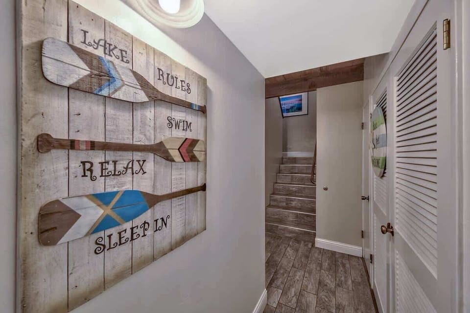 Charming hallway with rustic lake-themed décor—welcoming you with cozy vibes as you head toward the living spaces.
