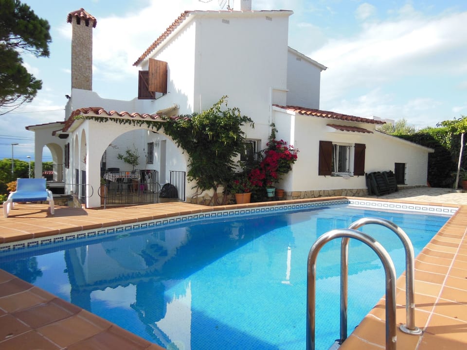Kitchen terrace leads to the pool and garden