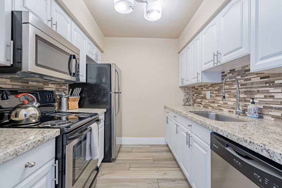 Full stocked kitchen with fridge, microwave, dishwasher and stove.  