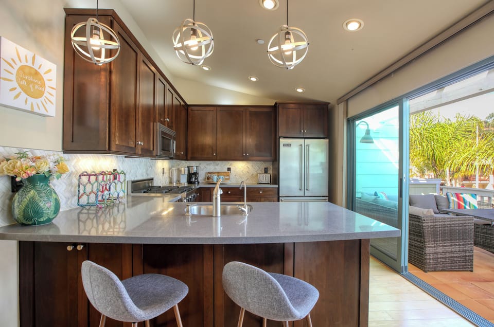 The heart of this beach house is its beautifully designed kitchen, equipped with chef-grade appliances to make cooking a breeze.