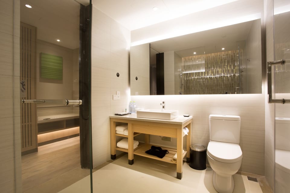 Designer toiletries, hair dryer, slippers, towels