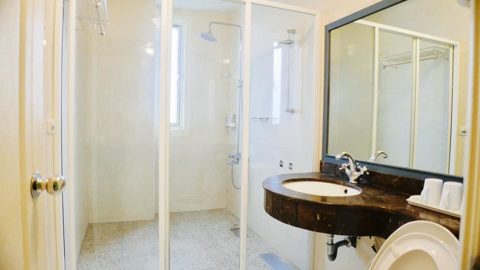 Shower, designer toiletries, hair dryer, slippers