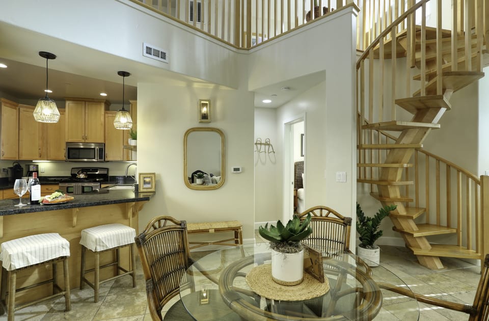 Open living space that opens into the courtyard. Just off the kitchen is a private patio. 

The living room has a queen sleeper sofa. 

For larger groups, there are more chairs and a folding table located in the closet.