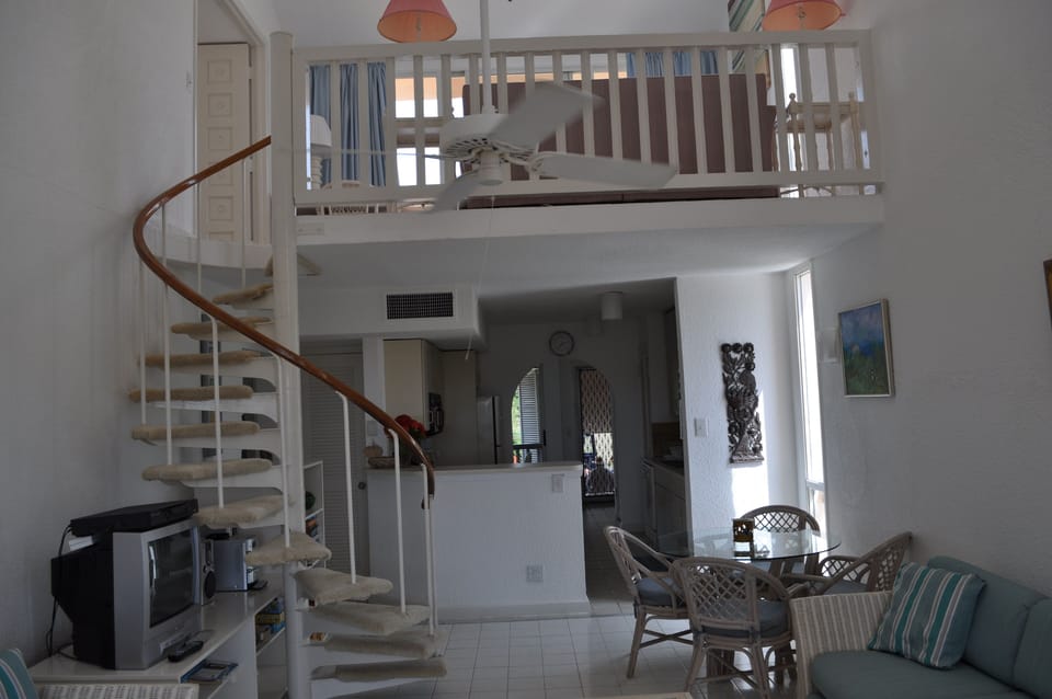 view from the den looking up to the upstairs landing