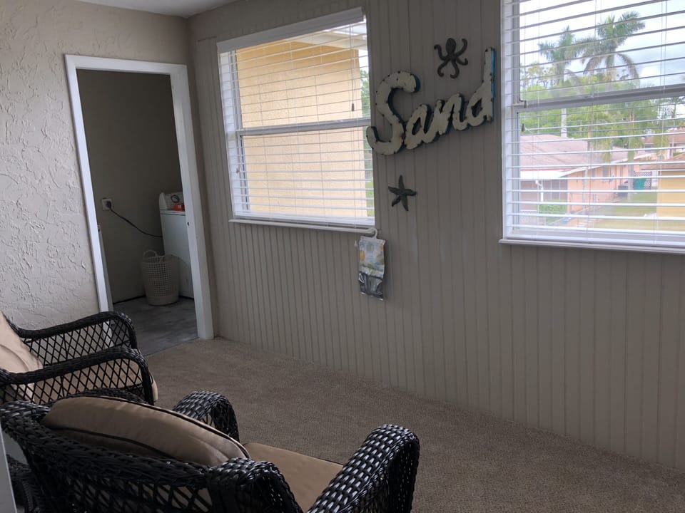 Florida room with amazing views of palm trees.  Perfect nook to read and relax.