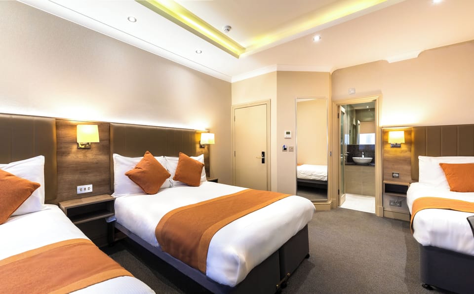 Standard Quadruple Room | In-room safe, desk, laptop workspace, blackout drapes