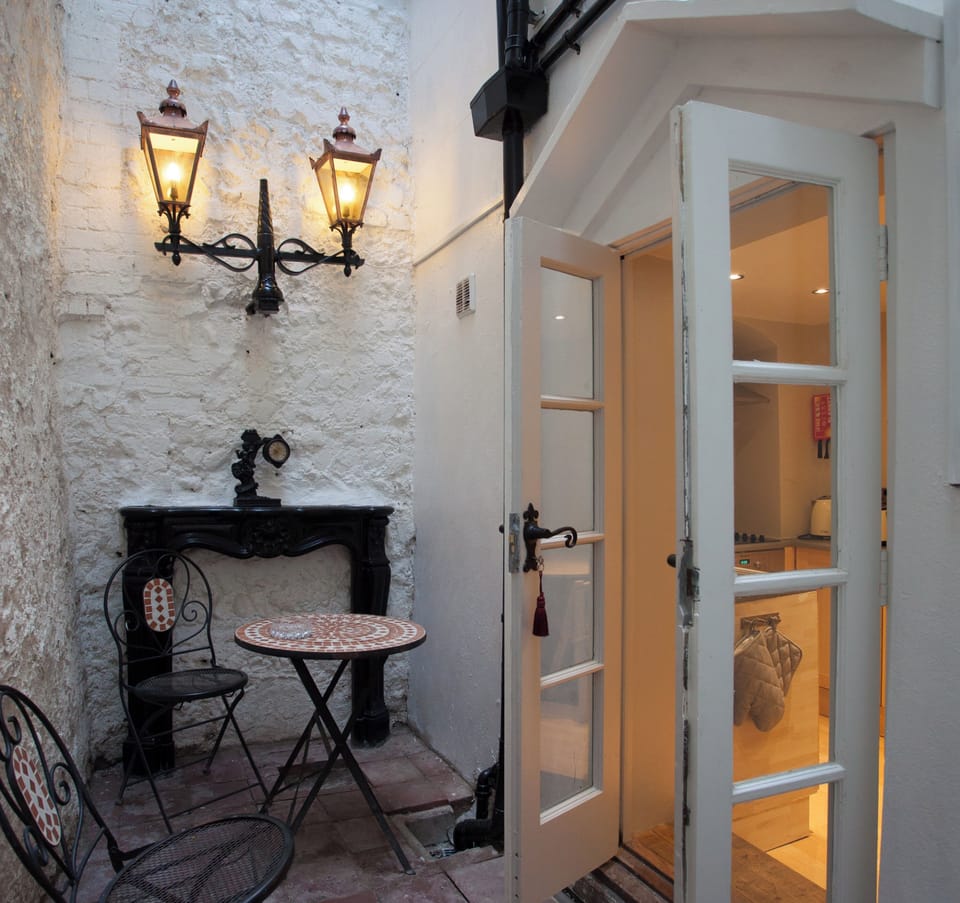 Street lamps & a fireplace decorate the patio garden