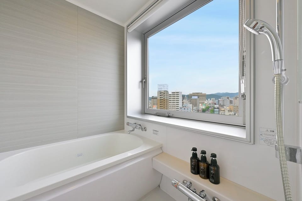 Corner Twin Room, Non Smoking | Bathroom | Eco-friendly toiletries, hair dryer, slippers, bidet