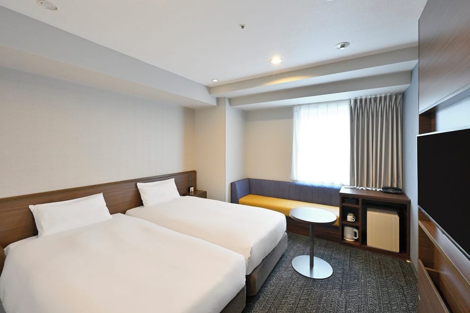 Corner Twin Room, Non Smoking | Down comforters, blackout drapes, iron/ironing board (on request)