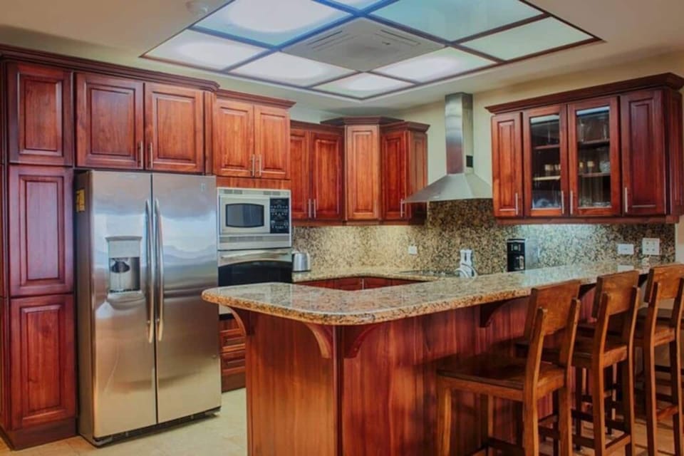 Inviting kitchen with spacious counter, full appliances, and tropical charm. Perfect for preparing meals after beach days. Located near Langosta Beach in Tamarindo, Costa Rica — ideal for families and groups seeking comfort and convenience.