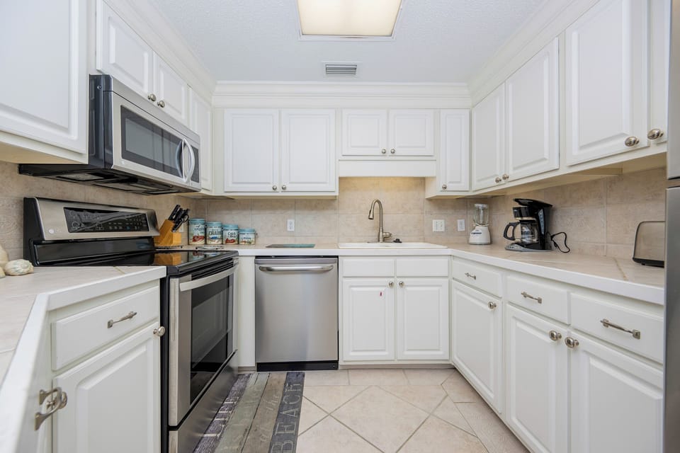 Prepare meals in this inviting kitchen featuring stainless appliances and ample counter space for your culinary adventures