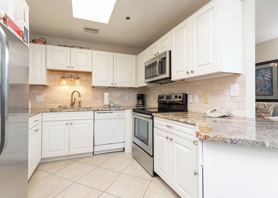 Prepare meals with ease in this stylish kitchen featuring granite countertops and stainless appliances