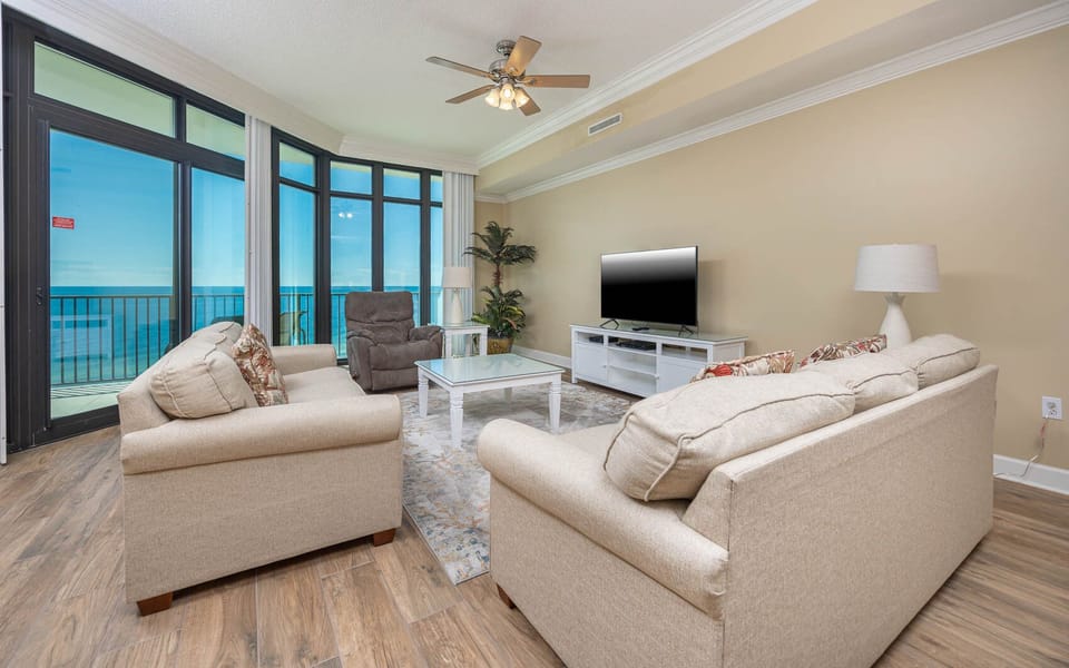 Feel the coastal vibe in this living space with a queen sofa sleeper while enjoying a movie and the stunning views