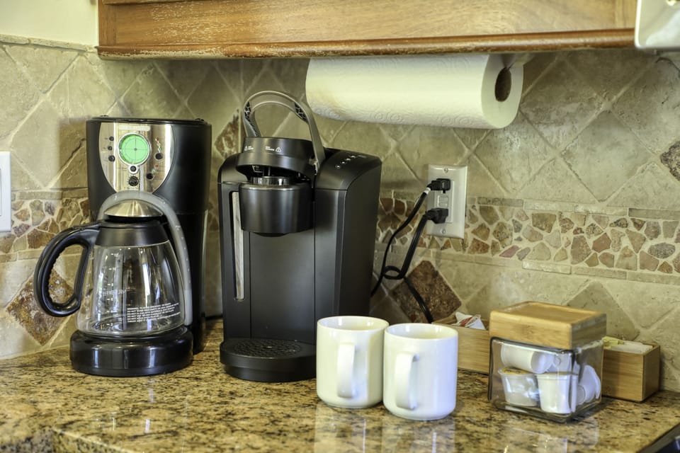 Kitchen furnished with a coffee maker and Keurig. A few coffee pods and sugar included.