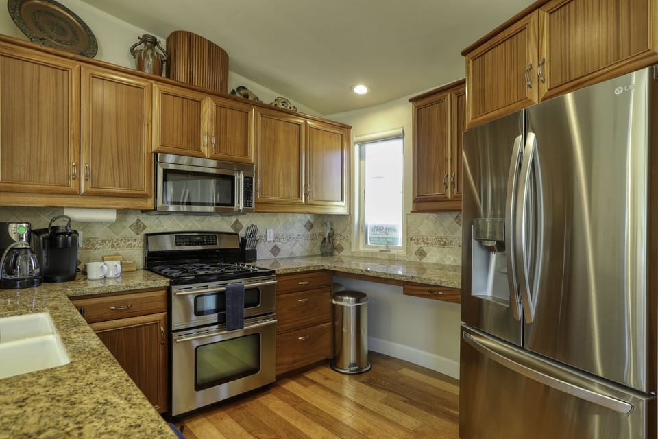 Stainless steel kitchen appliances.  Kitchen area extends into great room.