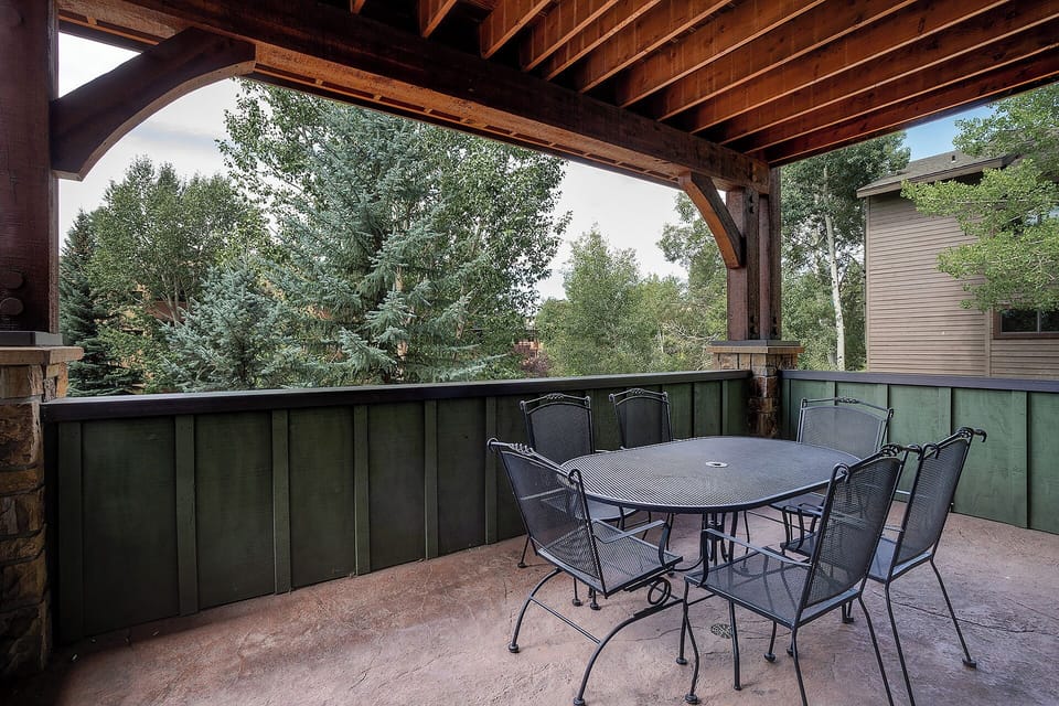 Your private covered terrace offers peaceful dining surrounded by mature trees, perfect for morning coffee or evening meals in nature's embrace.