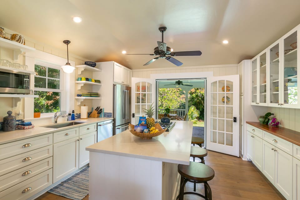 The kitchen is spacious and fully equipped, and opens up to the back lanai.