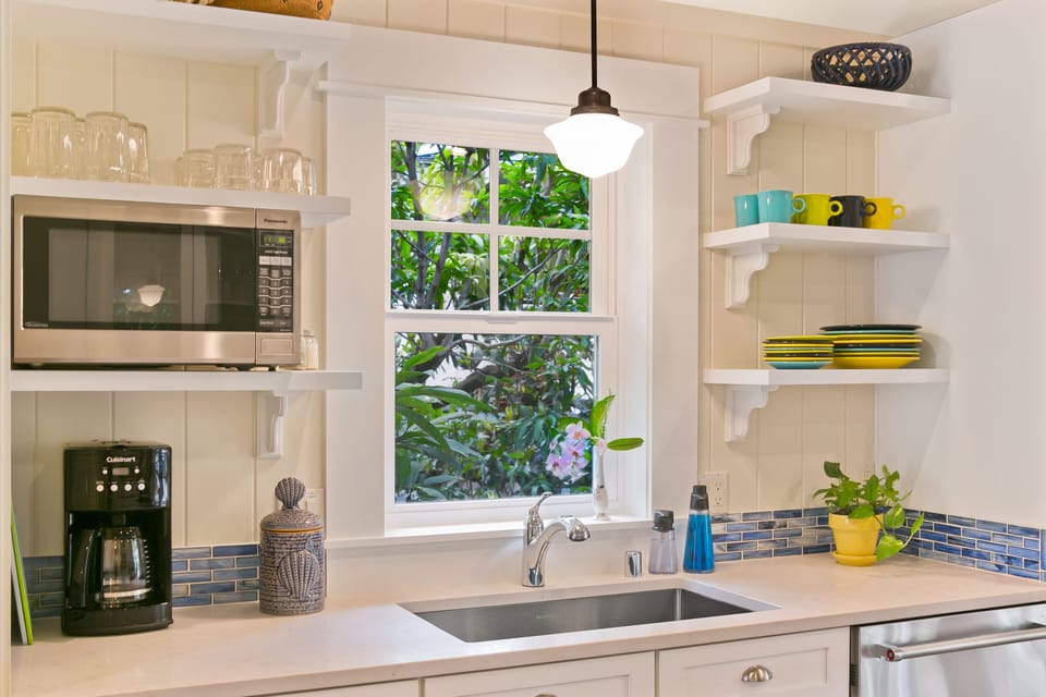 The kitchen window provides a view of plumeria, croton and mango trees.