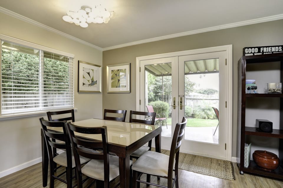 Experience seamless indoor-outdoor living as double doors off the dining room unveil a private, beautifully landscaped backyard oasis.