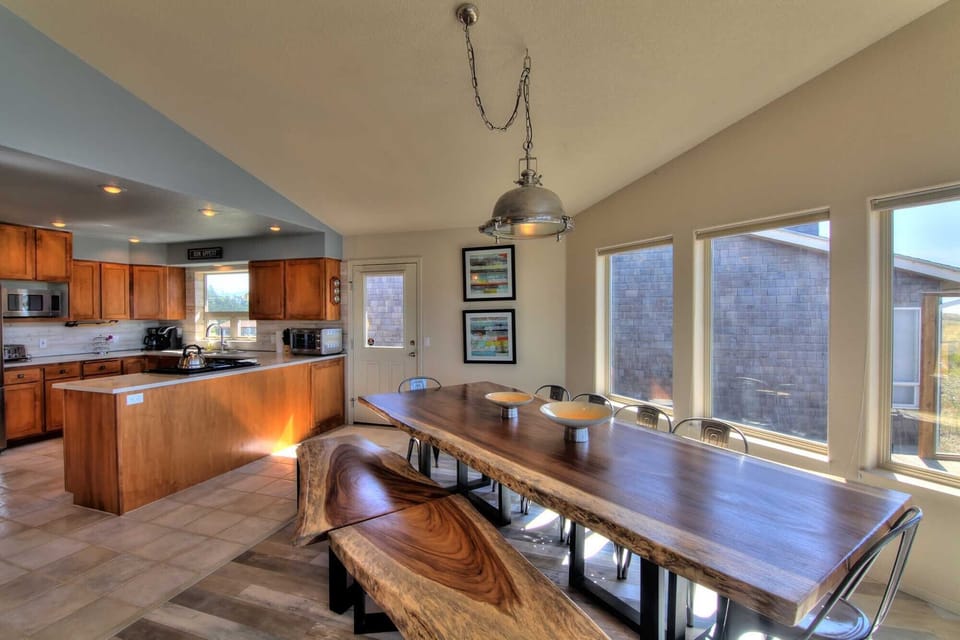 Both the stunning dining area and the amazing kitchen share the stunning vistas.