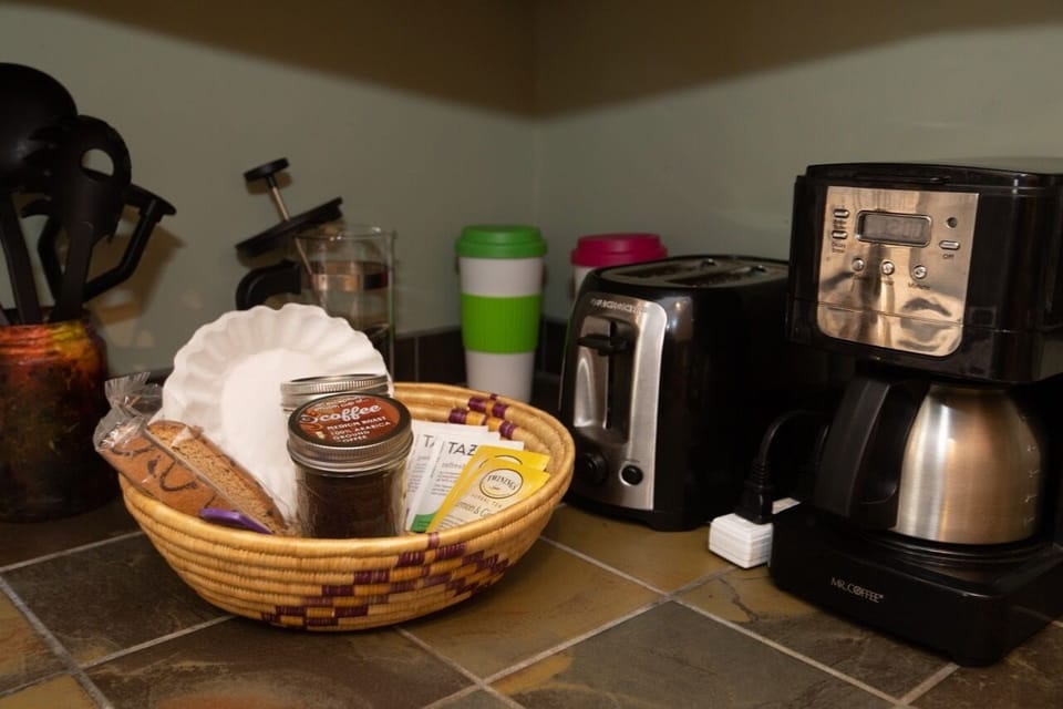 Coffee maker, french press, toaster, tea kettle, and coffee and assorted tea.