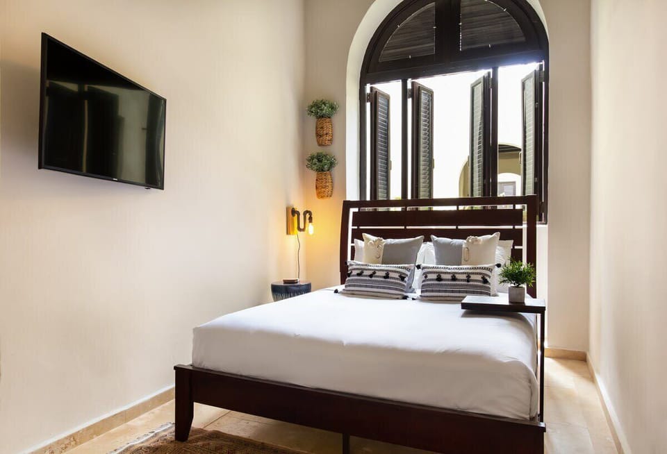 Second bedroom appointed with a queen bed, TV, AC