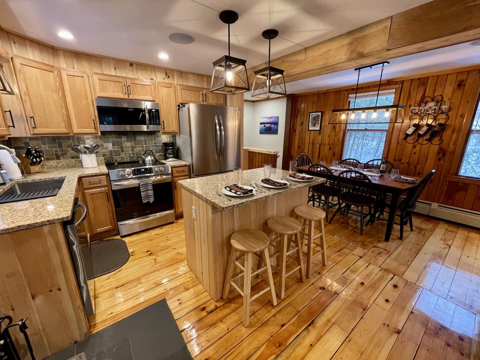 The fully-equipped, newly-renovated kitchen is open to the dining area