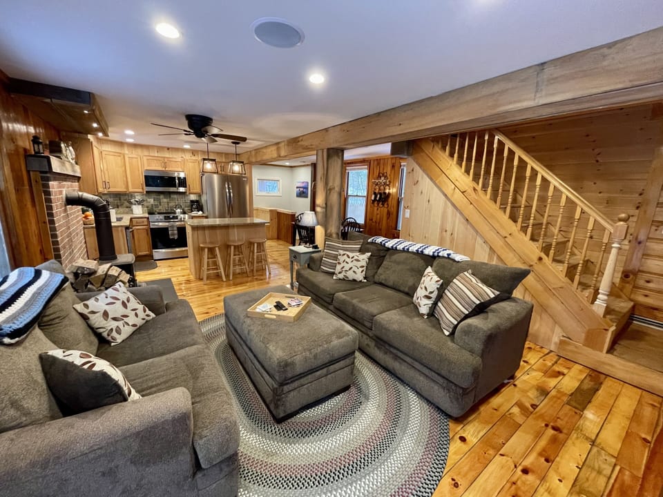 The cozy living room is open to the kitchen and dining area