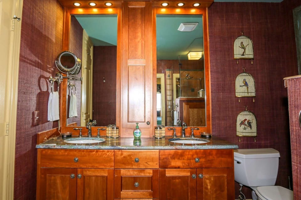 The primary en suite bathroom features a dual-sink vanity.