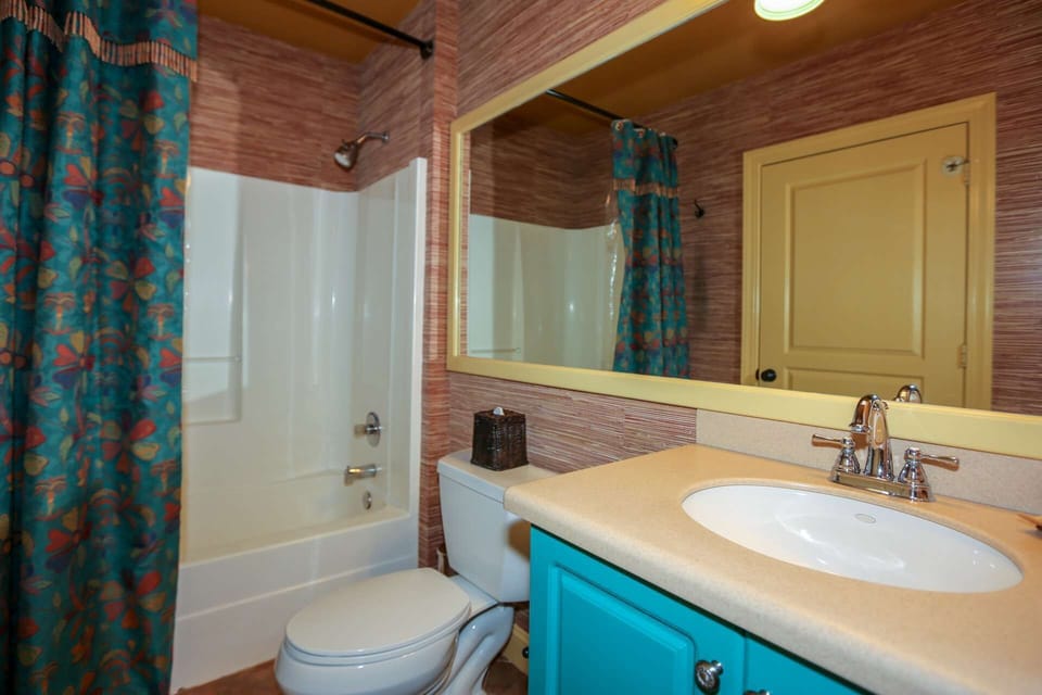 This hallway bathroom with a tub & shower is also accessible from the queen suite.
