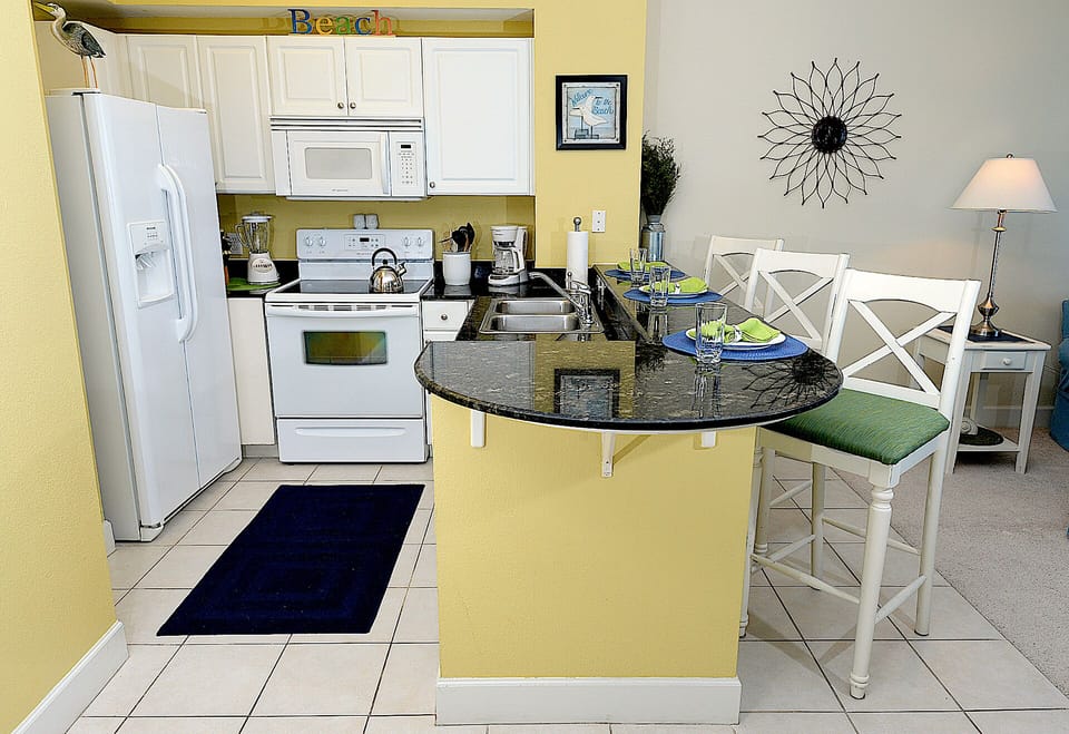 The open-concept Kitchen is FULLY STOCKED to serve all of your cooking needs