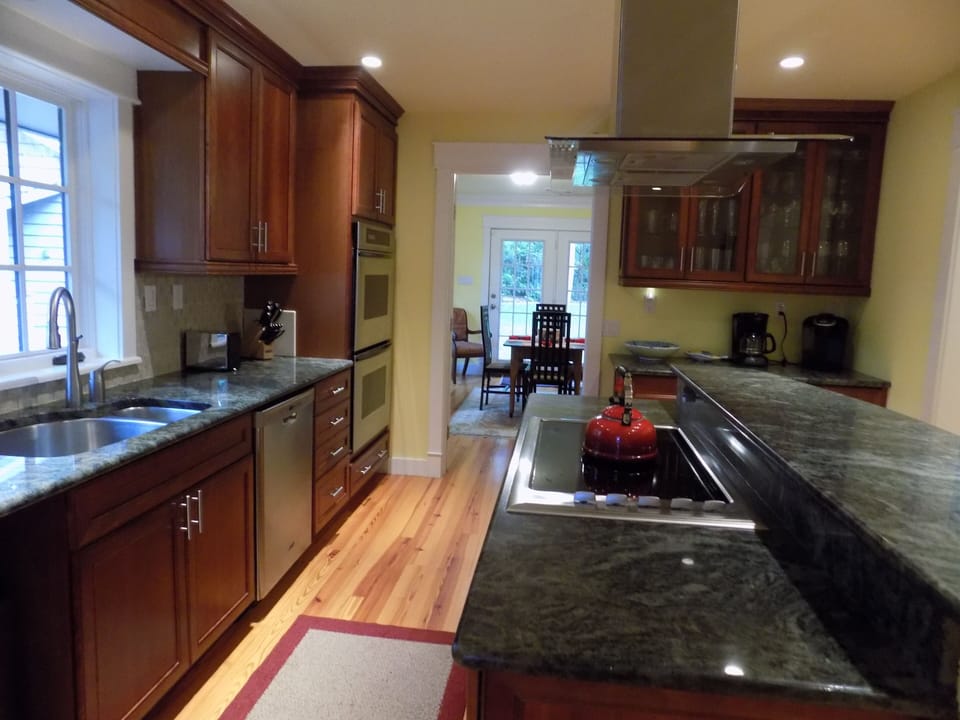 Kitchen breakfast bar with view into breakfast room and great room