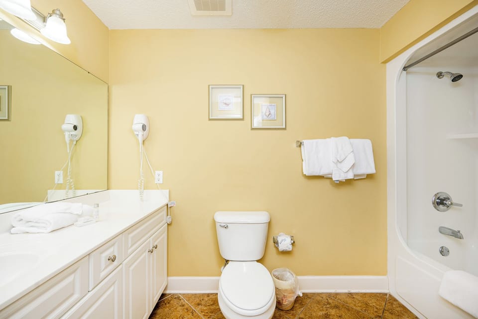 Freshen up in this guest bath in the relaxing shower or soothing tub before an exciting beach day