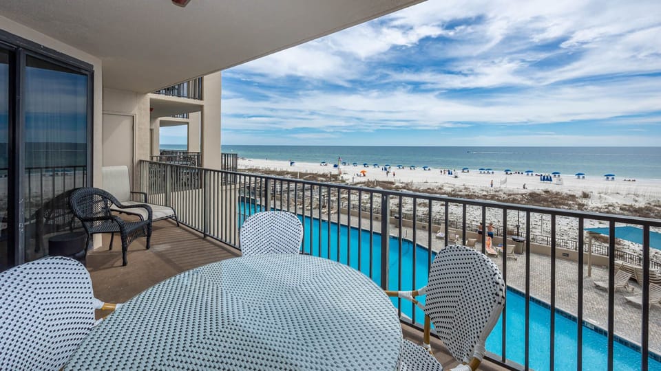 Enjoy meals or drinks on the balcony while taking in views of the beach and the inviting pool below