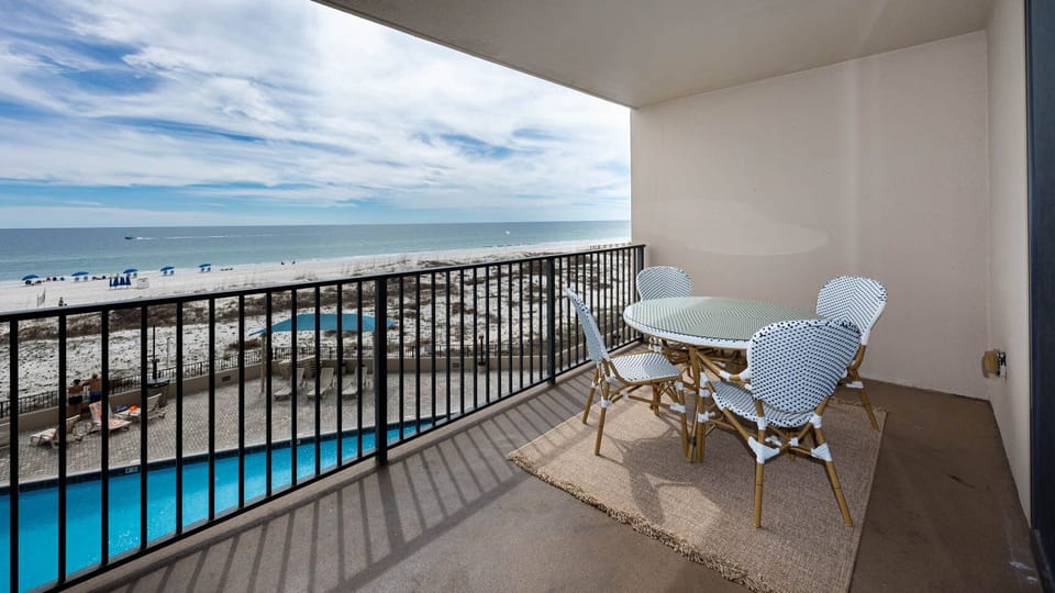 Inviting pool and the beach views from this spacious balcony over the pool area