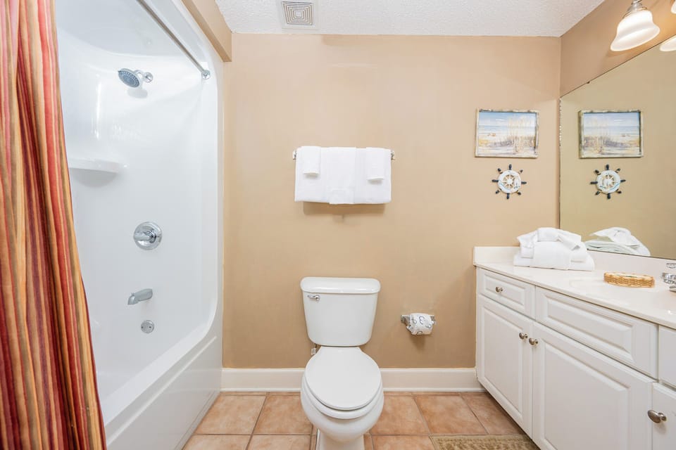 Enjoy a relaxing shower after a day of adventure in this guest bath with stylish accents and fluffy towels