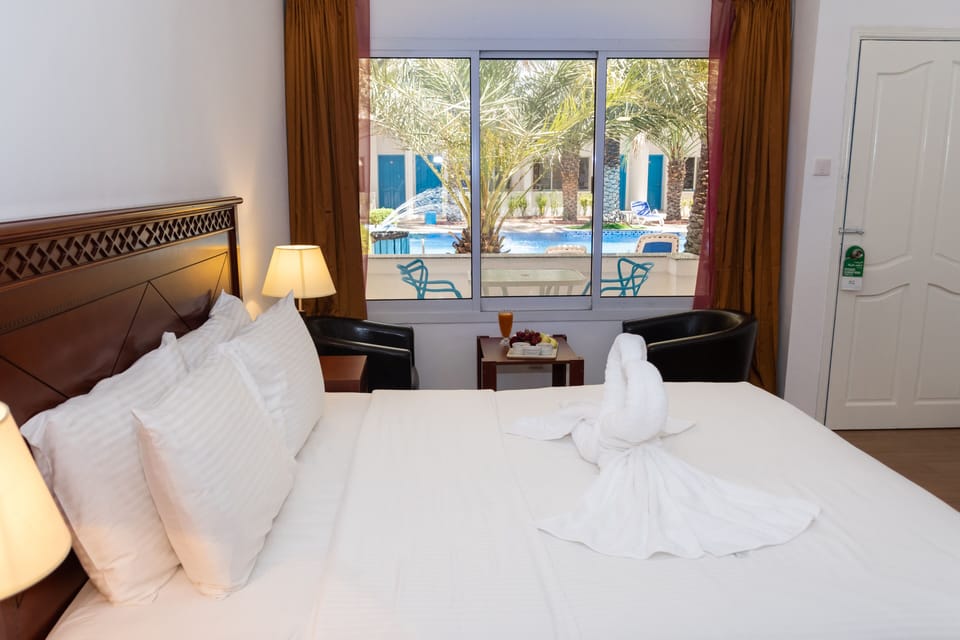 Deluxe Double Room, 1 Bedroom, Pool View | Iron/ironing board, WiFi (free), bed sheets