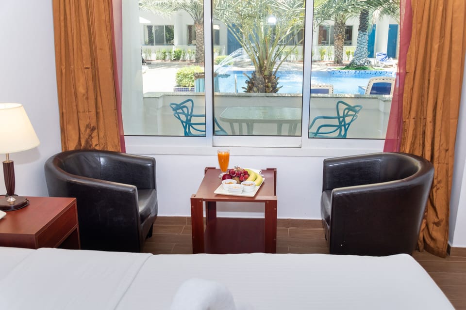 Deluxe Double Room, 1 Bedroom, Pool View | Iron/ironing board, WiFi (free), bed sheets