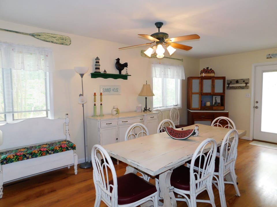451D Garfield Pky, Bethany Beach - Dining area - Perspective of the dining area featuring a ceiling fan and natural light from large windows.